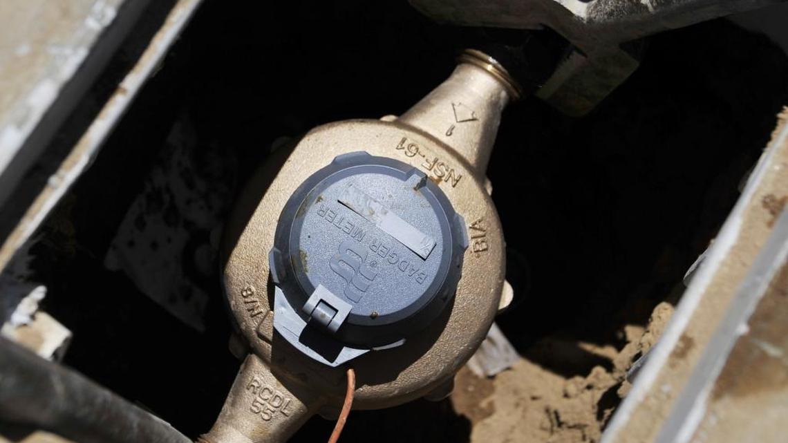
A water meter in the sidewalk in front of a house being constructed in Clovis.
