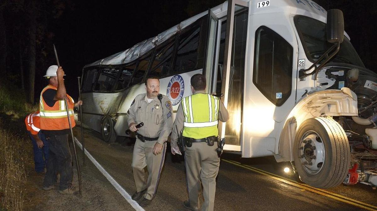 CHP officers get ready to clear workers to tow a tour bus from the scene where it crashed on Highway 41 north of Oakhurst on Saturday, Sept. 24, 2016.