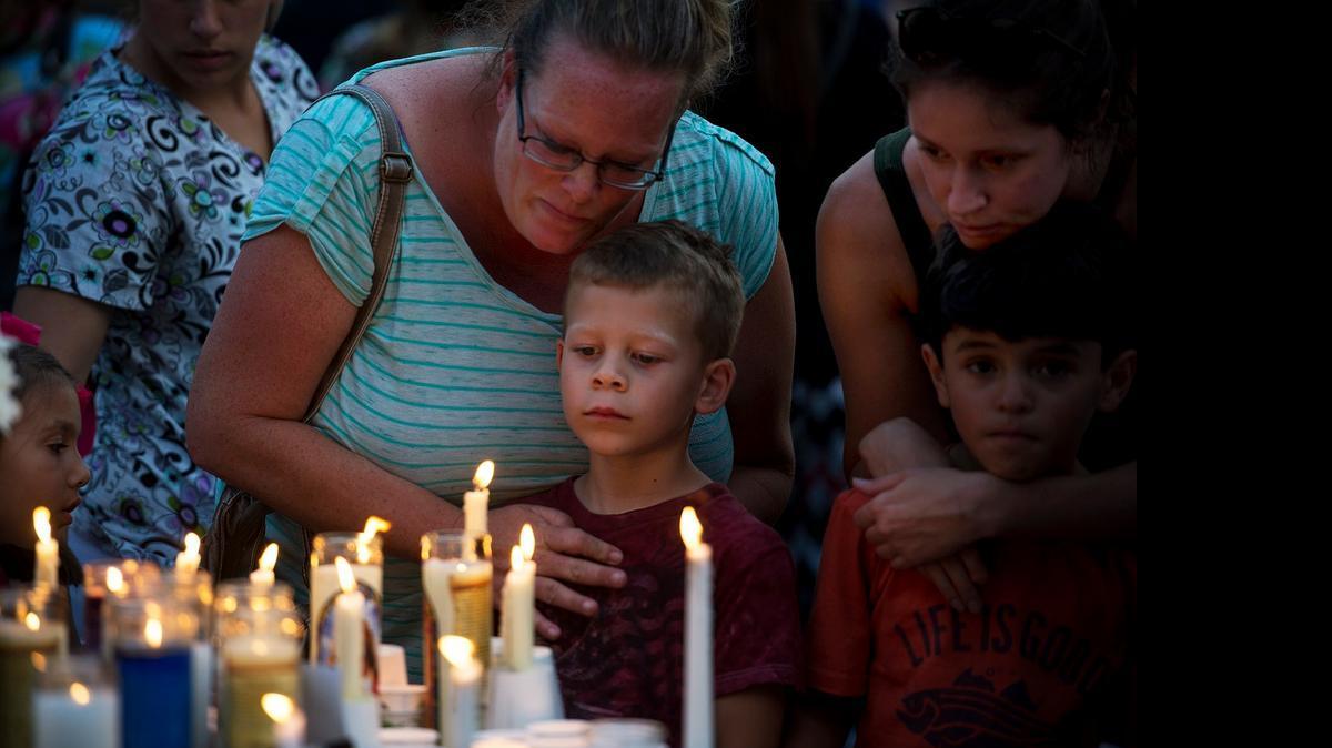 
From left, Misty Fulton and her son Nicholas, 6, Meghan Rupp and her son Matix, 6, remember slaying victims Dr. Amanda Crews and her children during a vigil at Standiford Park in Modesto on Monday. Both boys were classmates with Crews’ daughter Elizabeth, who was killed. 
