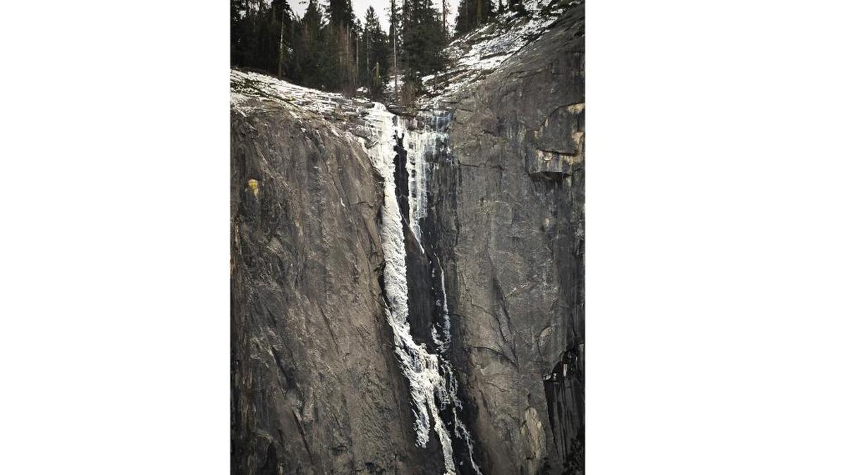 Silver Strand Falls is frozen in place on its cliff face, to the southwest and above the Tunnel View overlook in Yosemite National Park. Because most visitors’ gaze is directed toward the Yosemite Valley, Silver Strand is perhaps the most overlooked of Yosemite’s waterfalls, as seen last Friday, Dec. 8, 2017.