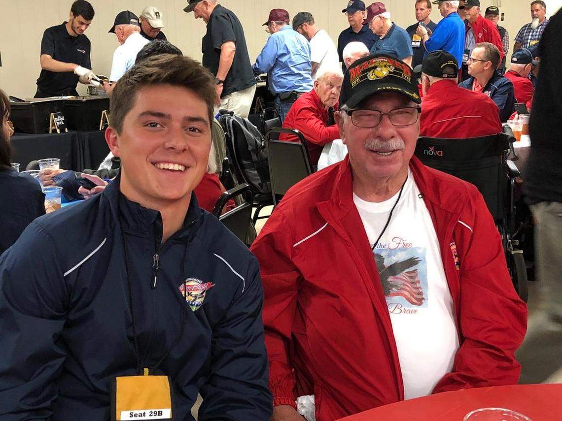 Hayden Tarr and Korean War veteran Roy Cochran Jr. smile during a barbecue dinner held during the 18th Central Valley Honor Flight to Washingtin, D.C., war memorials.