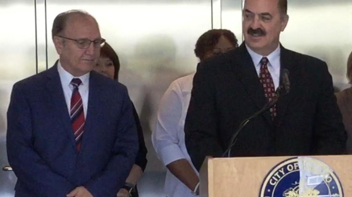 Newly hired Fresno police auditor John Gliotta, right, talks to reporters after he was introduced Wednesday by Mayor Lee Brand, left.