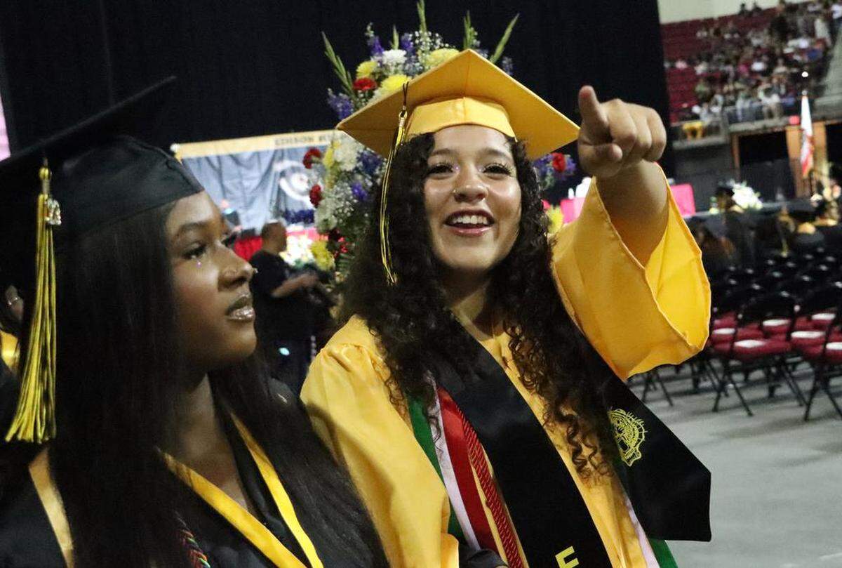 A graduate points out someone during the Edison High School graduation ceremony at the Save Mart Center on June 5, 2023.