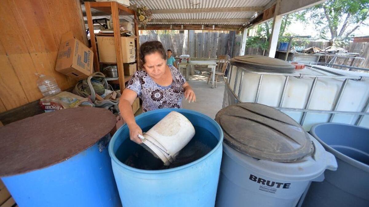 
Juana Garcia, 49, fills a bucket with donated nonpotable water on her back porch in East Porterville. She uses the water to flush the toilet inside the house. Garcia, a single mother, is struggling to endure the drought while dealing with feelings of helplessness and depression. Garcia’s well went dry close to two years ago.
