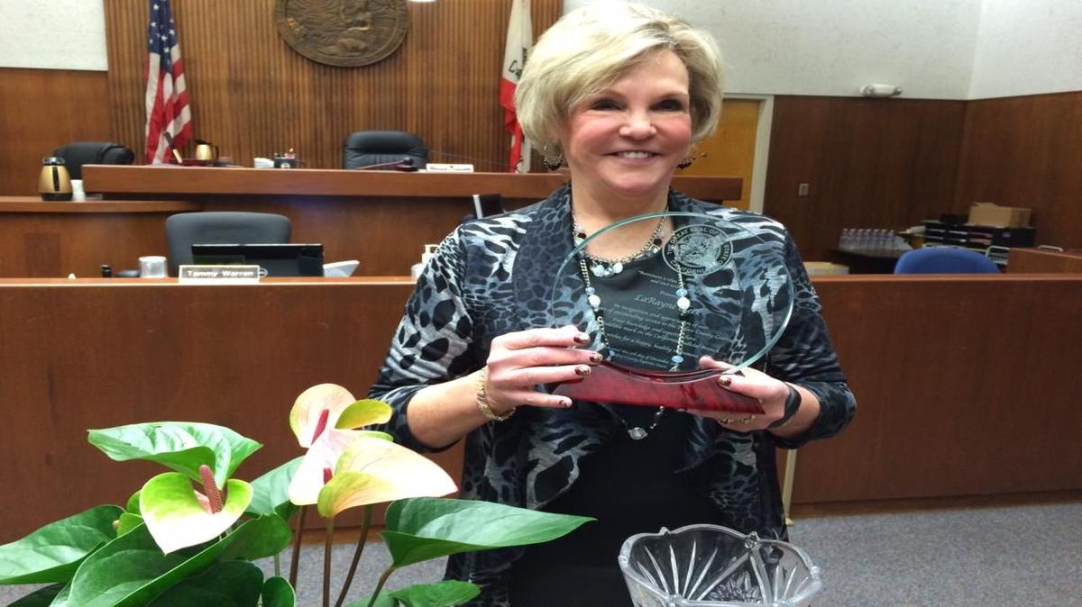 Tulare County Superior Court executive officer LaRayne Cleek poses with a plaque of recognition from the Tulare County District Attorney’s Office.