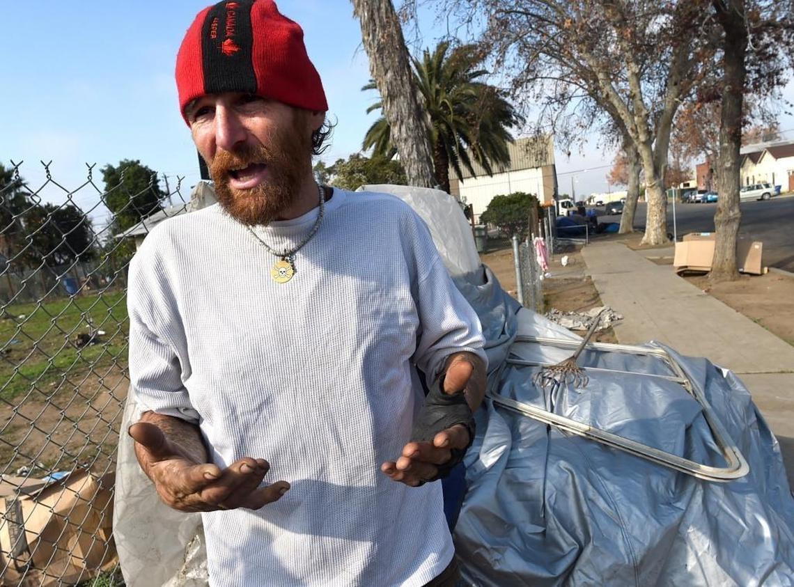 Next to his lean-to, Dysten Bane, 38, has been homeless for seven years. He says Fresno’s no-camping ordinance keeps him on the move daily.