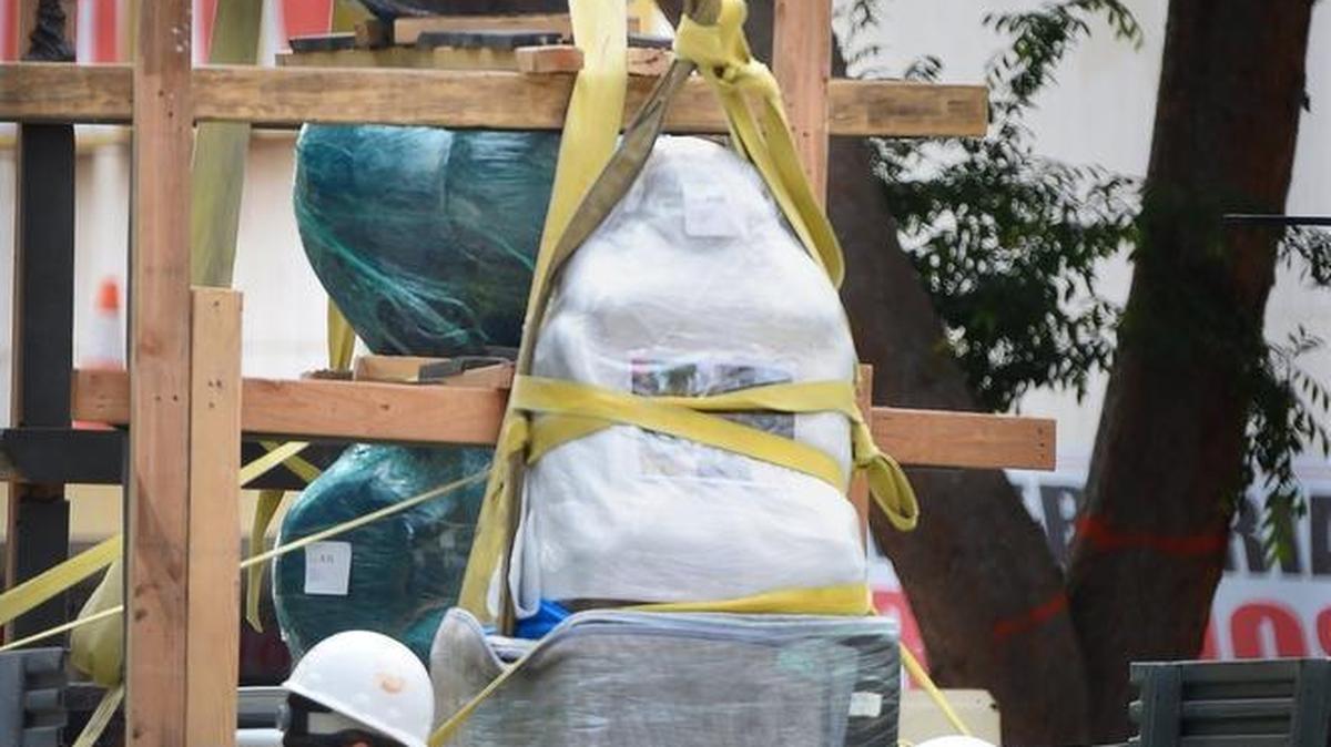 Workers prep “Mother and Child” by artist Raimondo Puccinelli, front, by wrapping the pedestal in layers of blankets, then wrapped in protective plastic. In back is the sculpture “Obos” by George Tsutakawa. The two sculptures from downtown Fresno’s Fulton Mall will go to Los Angeles for conservation as part of the city's $20 million project to reopen the six-block mall to automobile traffic.