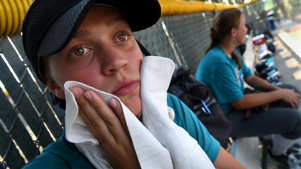 Rosey-cheeked Isabella Esparza of the Hurricanes softball team from Vallejo seeks relief from the 108-degree heat at the Buchanan High softball complex in late July 29. A new heat wave is about to bake the region.