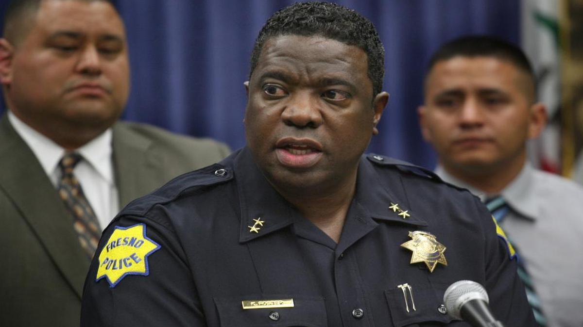 
Fresno police Deputy Chief Keith Foster speaks to the media in a 2012 press conference, flanked by detectives and uniformed police. He later resigned amidst an investigation into drug dealing. Foster’s financial troubles have led to a new recommendation by the city’s independent police auditor that top officers report their finances.
