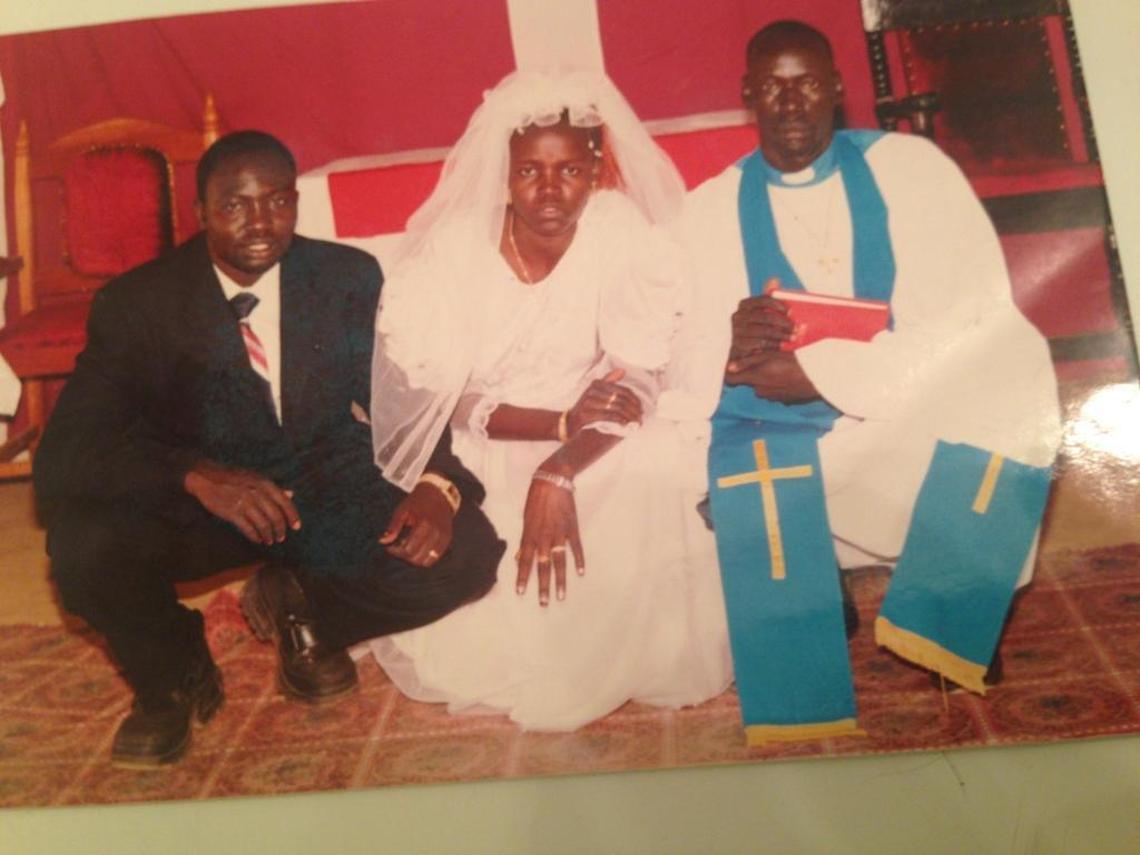 Jacob Awar Ayuen, one of the “Lost Boys of Sudan,” on the left, with his wife, Alakiir Deng, at their wedding in 2004 at Kakuma Refugee Camp in Kenya.