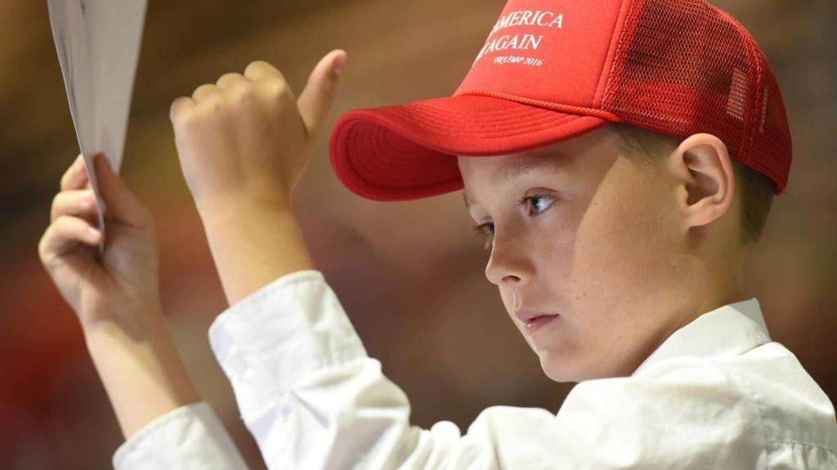 Powers-Ginsburg third grader Logan Autry, wearing his Make American Great Again hat, gives a thumbs up to Donald Trump during the candidate’s rally in Fresno on May 27.