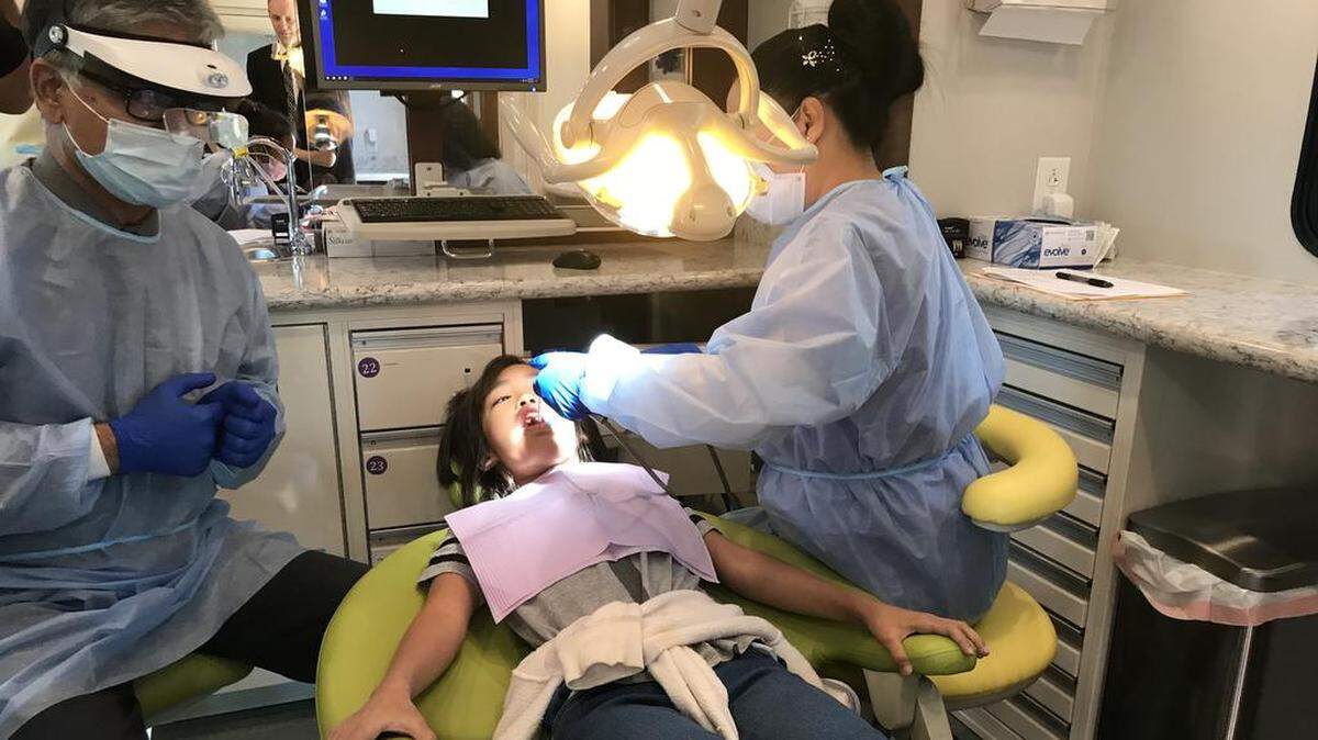 Keophet Phimmasone, 10, gets her teeth cleaned inside the new Mobile Dental Clinic at Mayfair Elementary School in Fresno on Friday, Oct. 19, 2018.