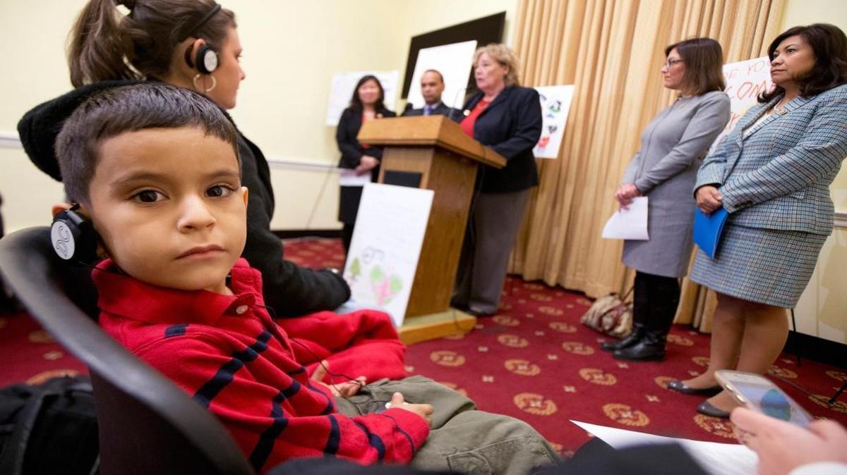 Coritza Mejia and her son Alejandro Granados, 5, listens as Rep. Zoe Lofgren, D-San Jose, accompanied by fellow lawmakers, speaks during “a wish for the Holidays” news conference on Capitol Hill in Washington, Wednesday, Dec. 9, 2015. Coritza Mejia and her son Alejandro Granados, from Honduras, were detained in Dilley, Texas for two months and later released. They are in the process of applying for asylum.