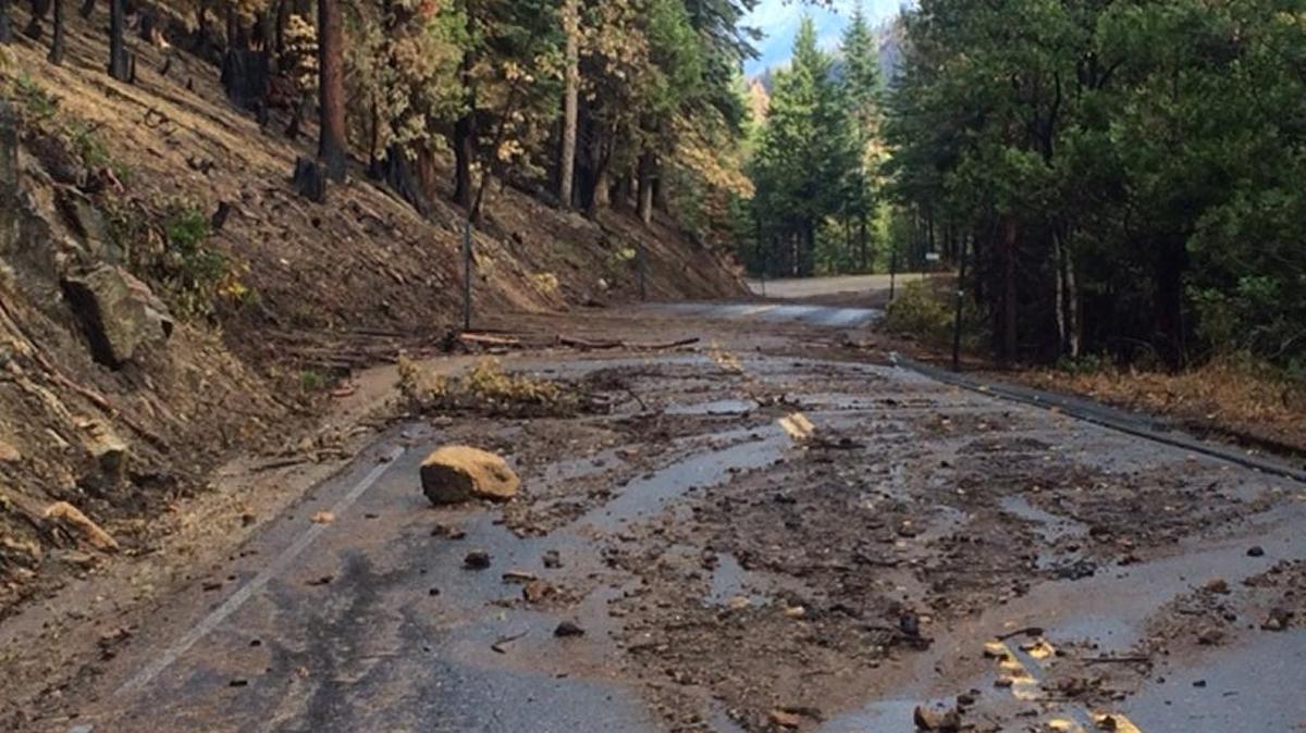 Rock, mud and debris remain on a closed road in the Sierra National Forest following an afternoon rain storm in October 2015.