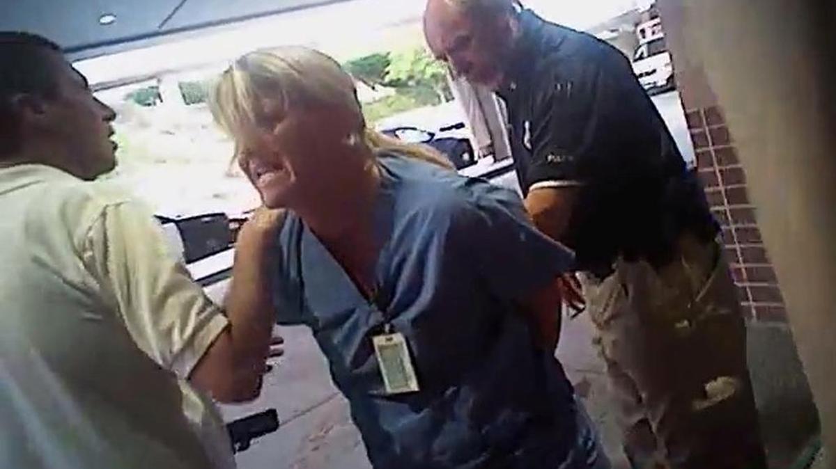 In this July 26, 2017, frame grab from video taken from a police body camera and provided by attorney Karra Porter, nurse Alex Wubbels is arrested by a Salt Lake City police officer at University Hospital in Salt Lake City. The Utah police department is making changes after the officer dragged Wubbels out of the hospital in handcuffs when she told him he couldn't draw blood on an unconscious burn-unit patient.
