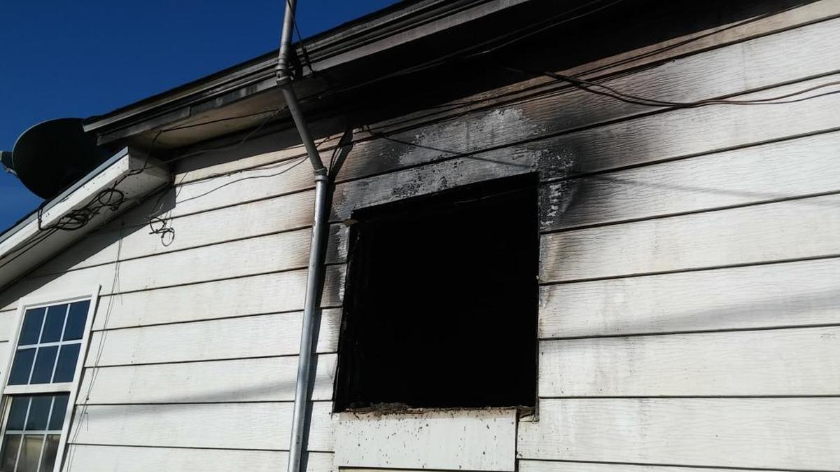 The exterior of a southwest Fresno home is blackened after a fire tore through it early Sunday, April 2.