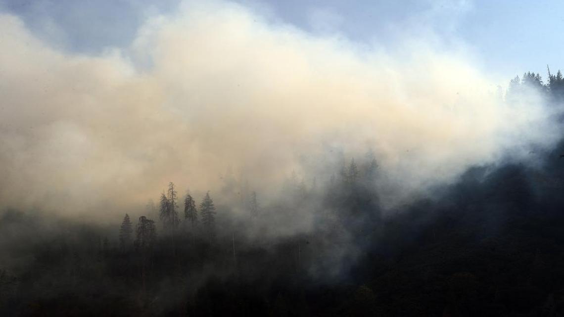 
Smoke billows off the mountains around Hume Lake due to the Rough fire in the Sierra National Forest.
