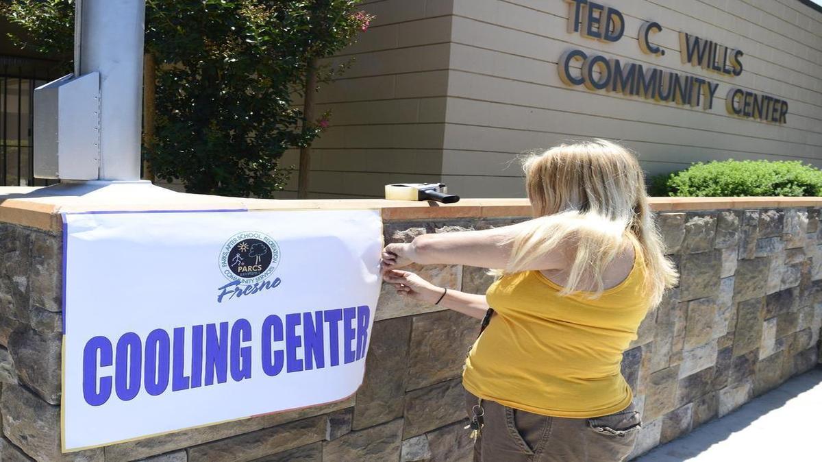 
Wendi Danyluk of the city of Fresno recreation department puts up a cooling center sign at the Ted C. Wills Center in Fresno Monday, June 8, which marked the first time this summer the centers opened.
