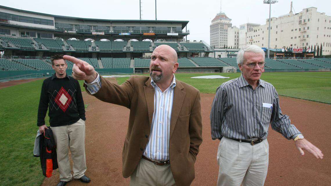 FRESNO , CALIF. -- -- 12/3/08 -- -- Center, Brian Glover, and at right, Chris Cummings talk about the changes to the lease agreement for Chukchansi Park. The city of Fresno and the Grizzlies have re-written the lease on the downtown stadium, Chukchansi Park. The stadium has always been city-owned, but the Grizzlies have always been a year-round tenant. Now the city will take over the stadium for nine months of each year. At left is Jason Hannold, director of tickets for the Grizzlies. MARK CROSSE/THE FRESNO BEE