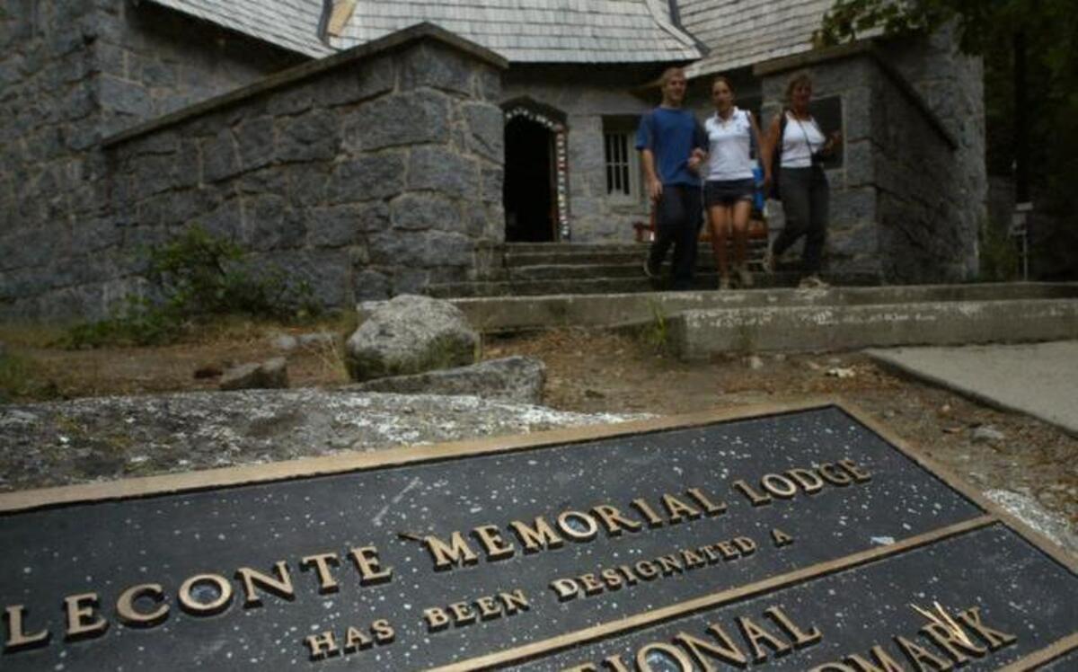 A plaque set into the ground lists the LeConte Memorial Lodge in Yosemite Valley as a national historic landmark.