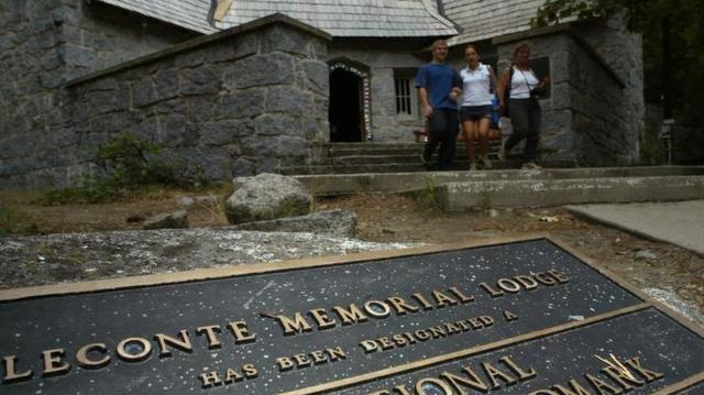 A plaque set into the ground lists the LeConte Memorial Lodge in Yosemite Valley as a national historic landmark.