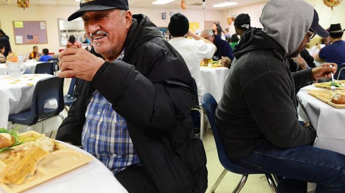 Juan Silvas enjoys a Thanksgiving dinner during the Poverello House’s annual Thanksgiving dinner for the homeless and needy Thursday, Nov. 24, 2016.