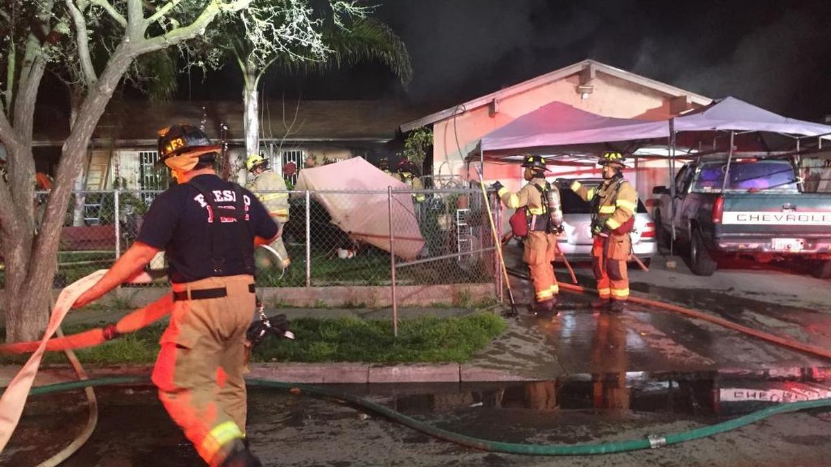 Firefighters battle a blaze in a southwest Fresno home Monday night, Feb. 15, 2016.
