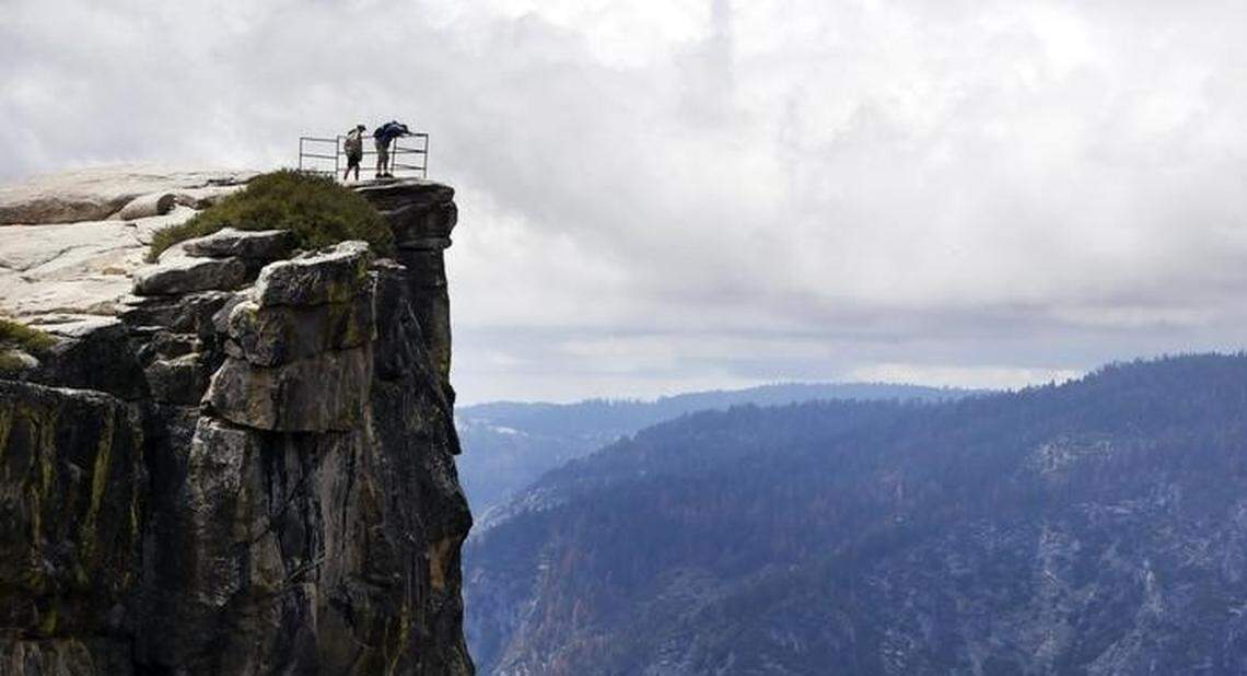 Visitors look down into Yosemite Valley from Taft Point Thursday, May 26, 2016 in Yosemite National Park.