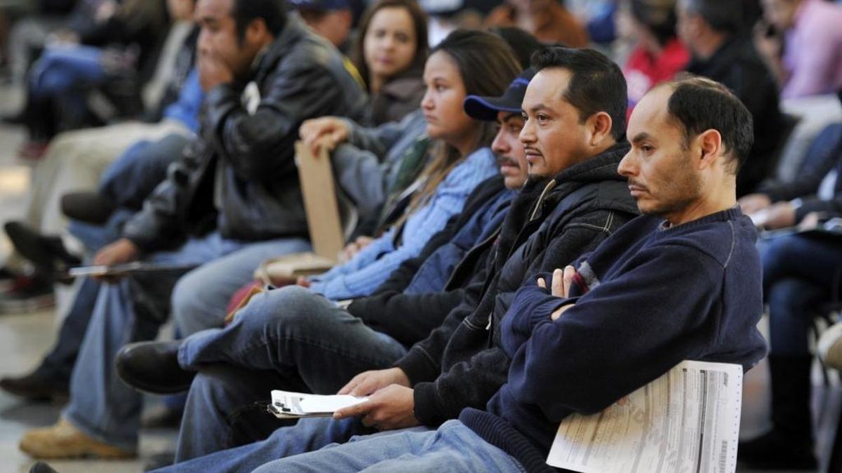 Applicants for state driver’s licenses meant for undocumented immigrants gather at a Department of Motor Vehicles office in Fresno on Jan. 2, 2011 – the first day they were eligible to apply.