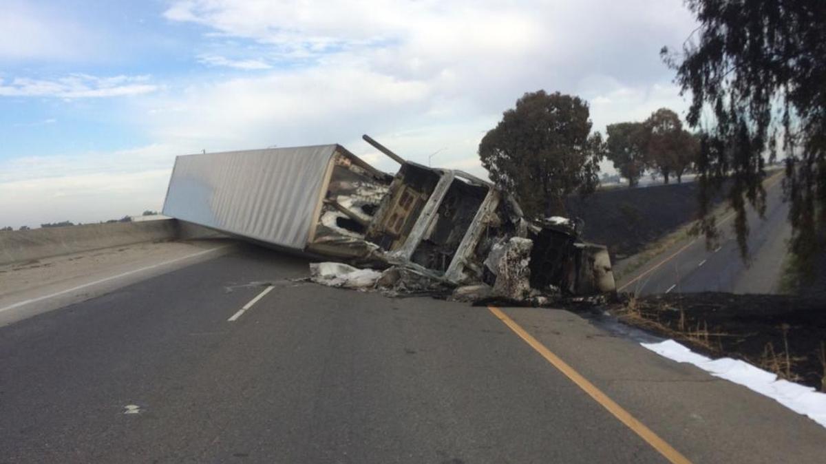 The remains of a tractor-trailer truck that crashed and burned Wednesday on the Highway 152 connecting ramp from northbound Highway 99.