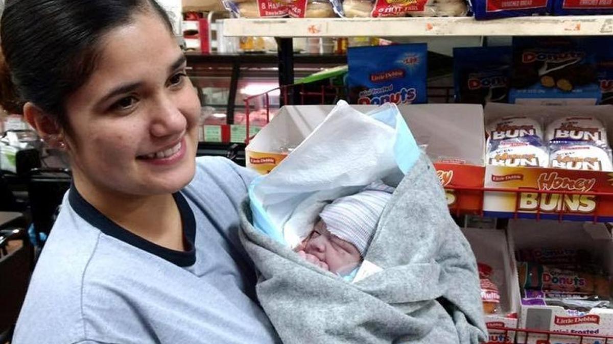 Issamar Sepulveda, who co-owns El Parian meat market in southeast Fresno, holds a baby boy born Tuesday, Dec. 26, 2017 inside her store.