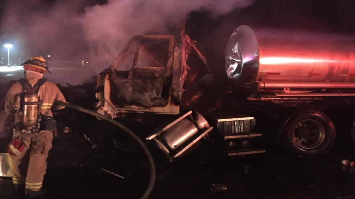 A Visalia firefighter attends to a tanker truck that crashed on Lovers Lane early Saturday morning, Jan. 7, 2016.