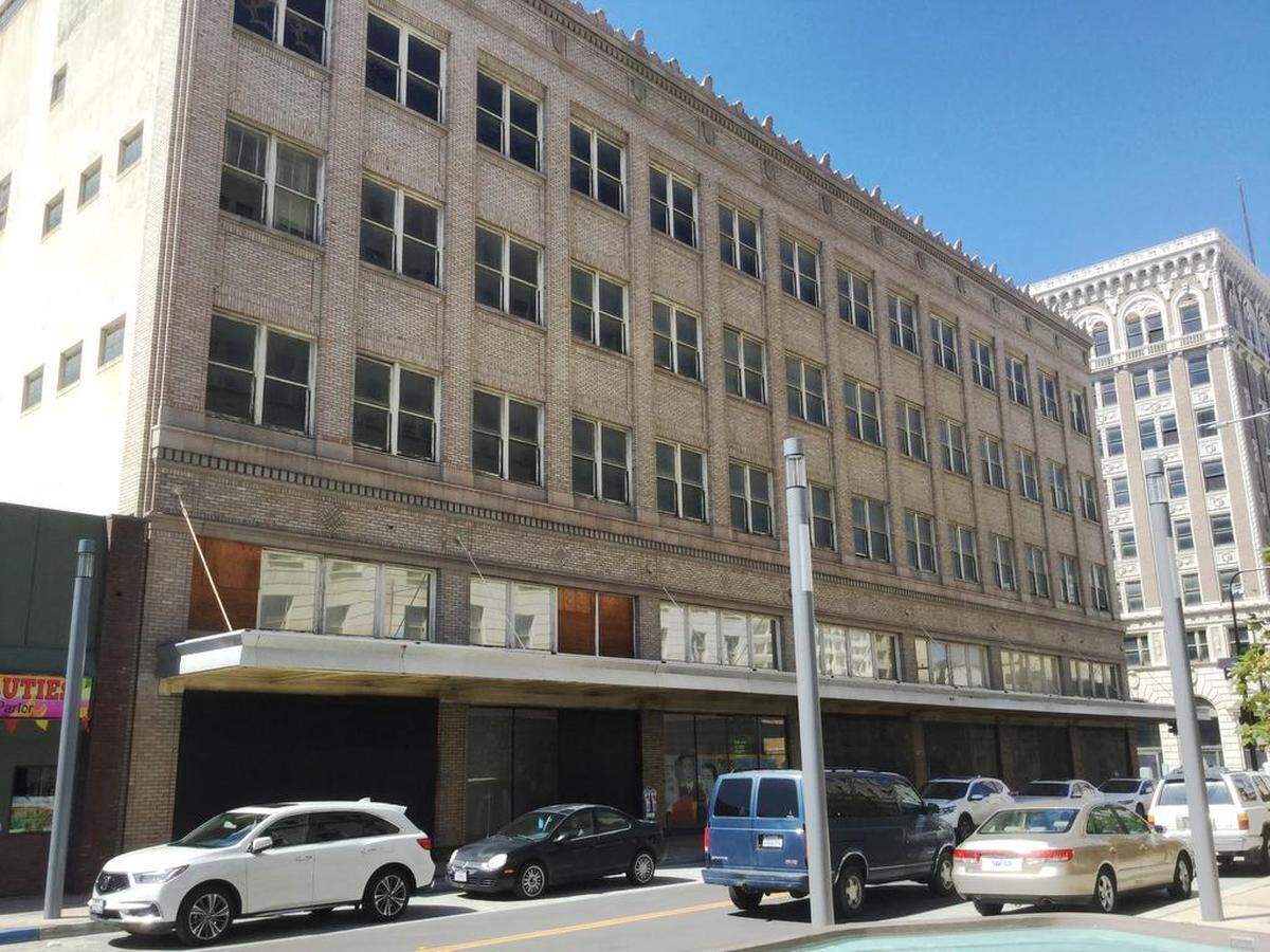 Boarded-up windows are visible on the front of the Radin-Kamp Department Store building, later home to J.C. Penney at the southwest corner of Fulton and Tulare streets. The structure, built in 1924, has been vacant for decades.