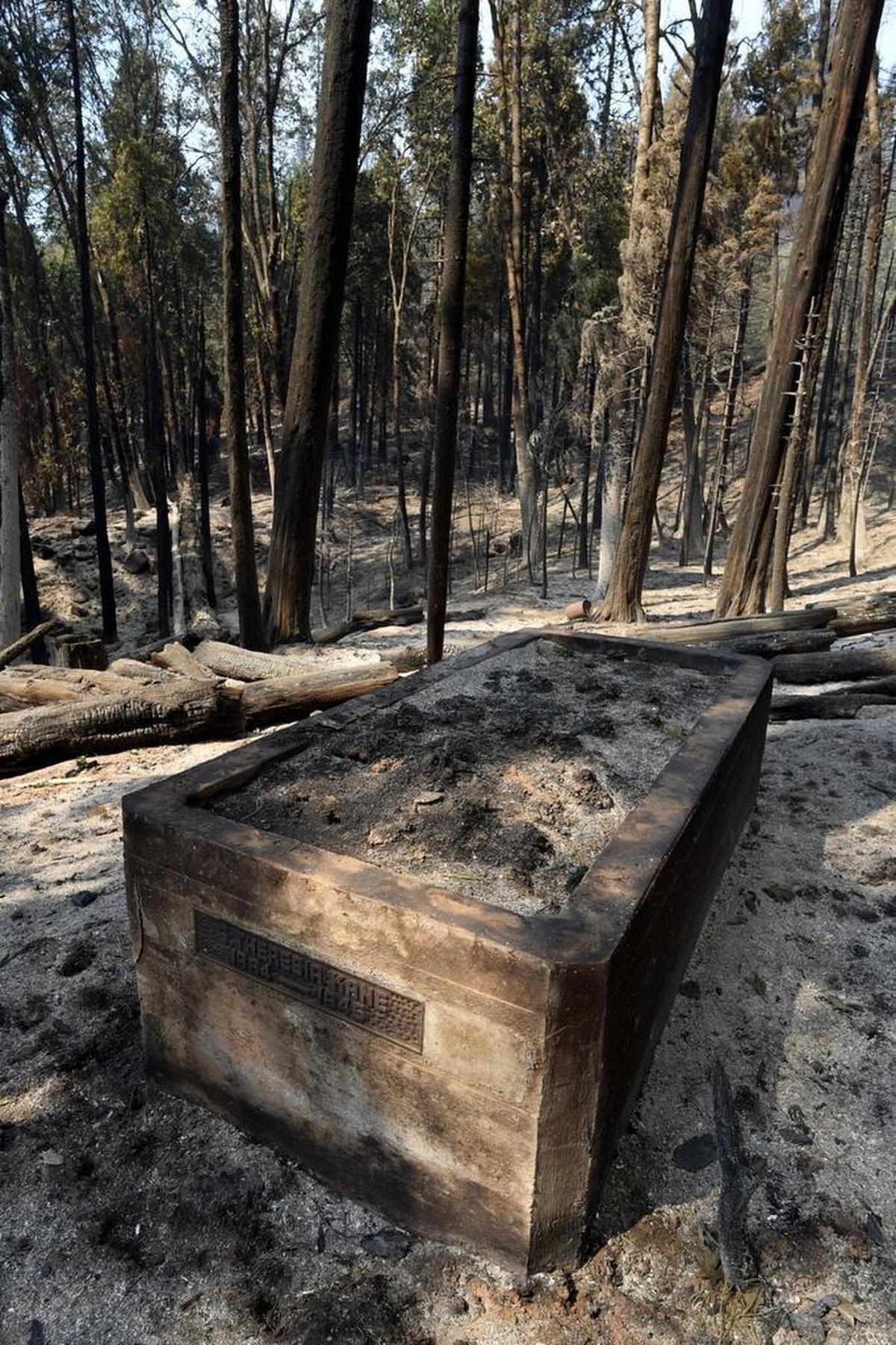 The charred crypt of a Fish Camp pioneer, S. Theresia Kane, 1864-1945, at a home that was destroyed in the Railroad Fire, near the Yosemite Mountain Sugar Pine Railroad, Sept. 2, 2017.