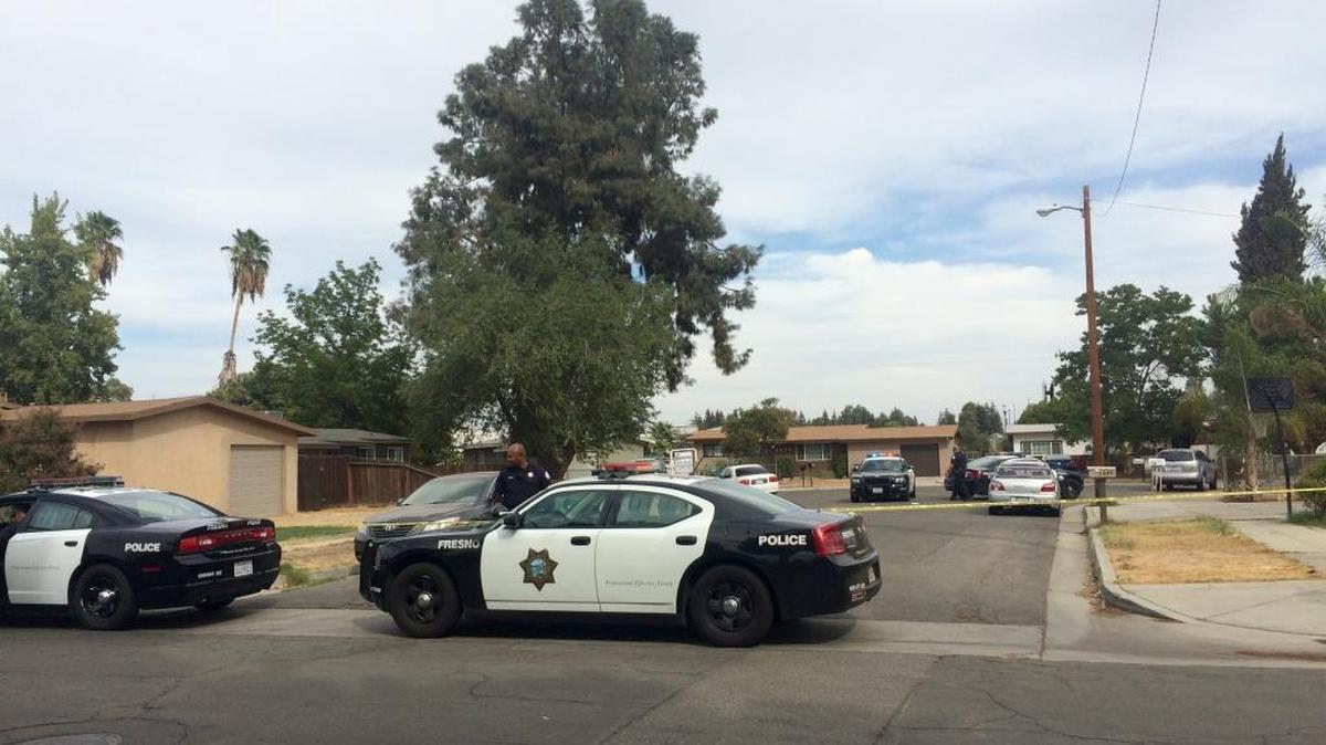 
Fresno police secure the cul-de-sac entrance near the northwest Fresno home where they say a 72-year-old man shot and killed his 39-year-old son. 
