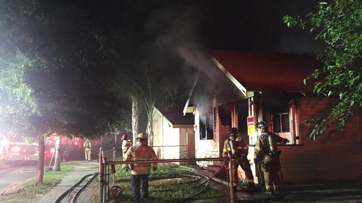 Fresno firefighters work to extinguish a blaze that engulfed a vacant home in central Fresno Tuesday night.