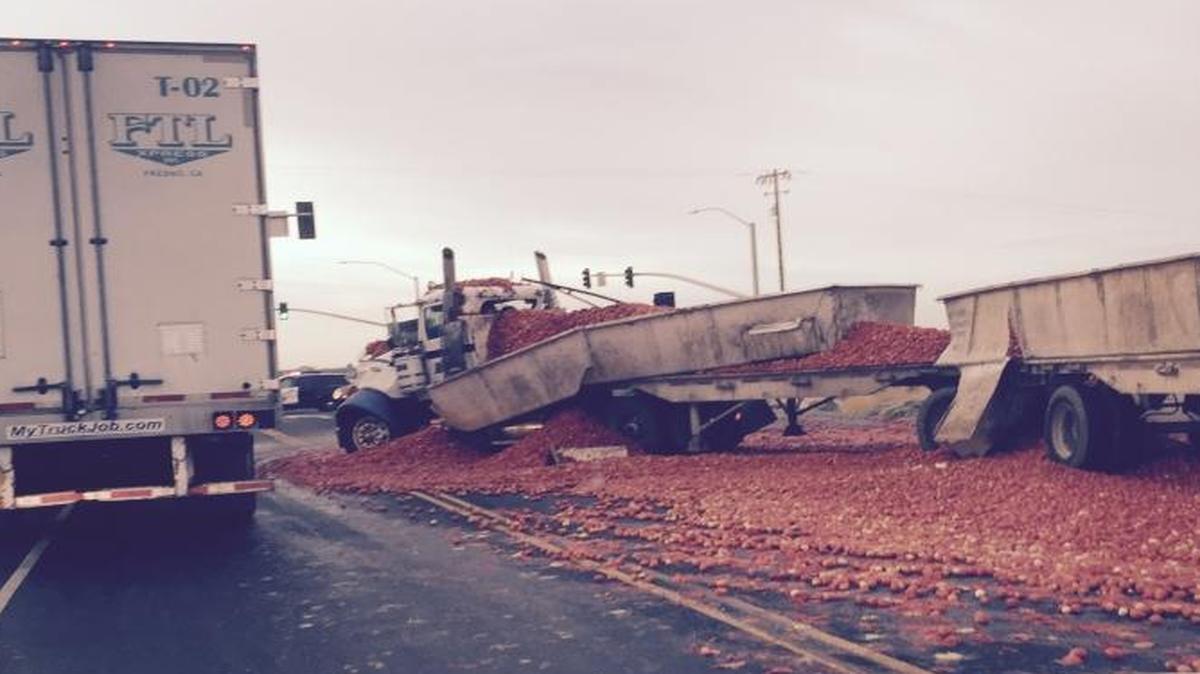 
A big rig makes its way around a load of spilled tomatoes on Highway 41 at Elkhorn Avenue on Wednesday, Sept. 30, 2015.

