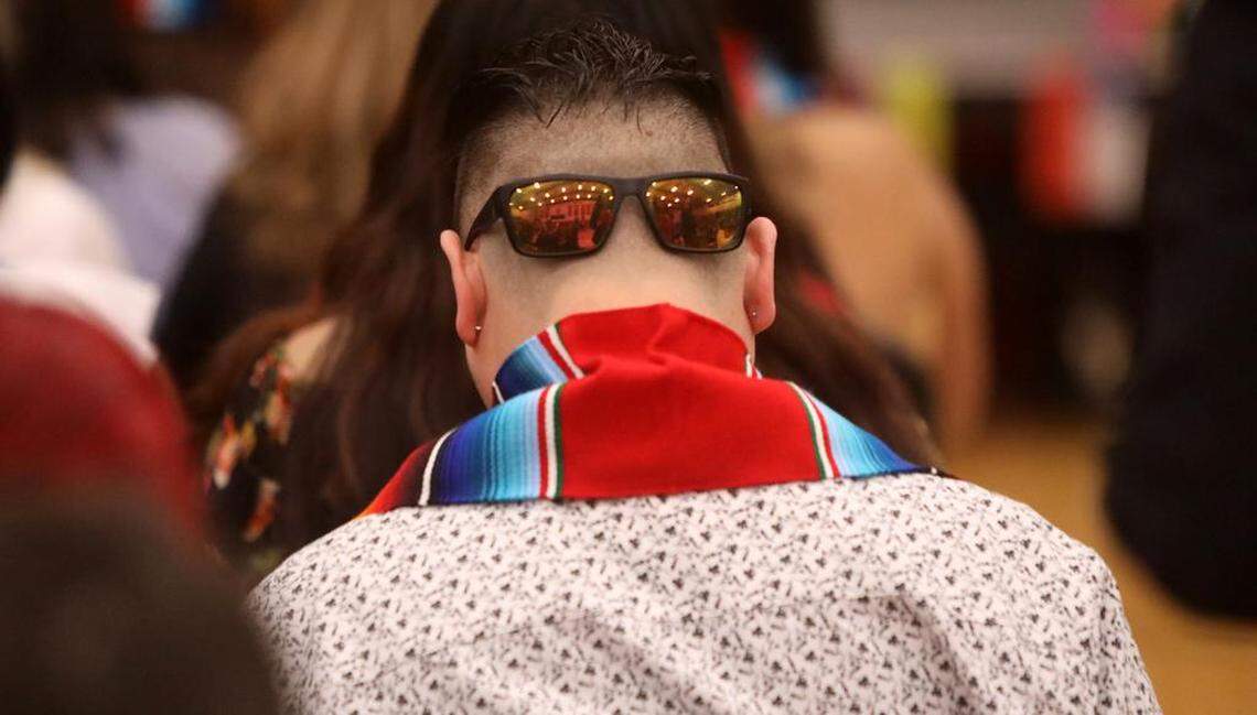 A graduate parks his glasses on the back of his head during the 21st Latino Graduation Celebration at the college gym on May 6, 2023.