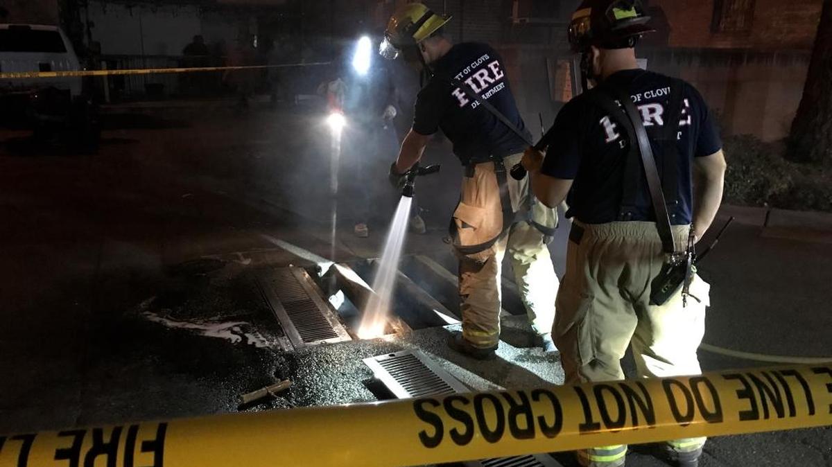 Clovis firefighters view an underground transformer at Fifth and Pollasky Avenue on Friday, August 18.