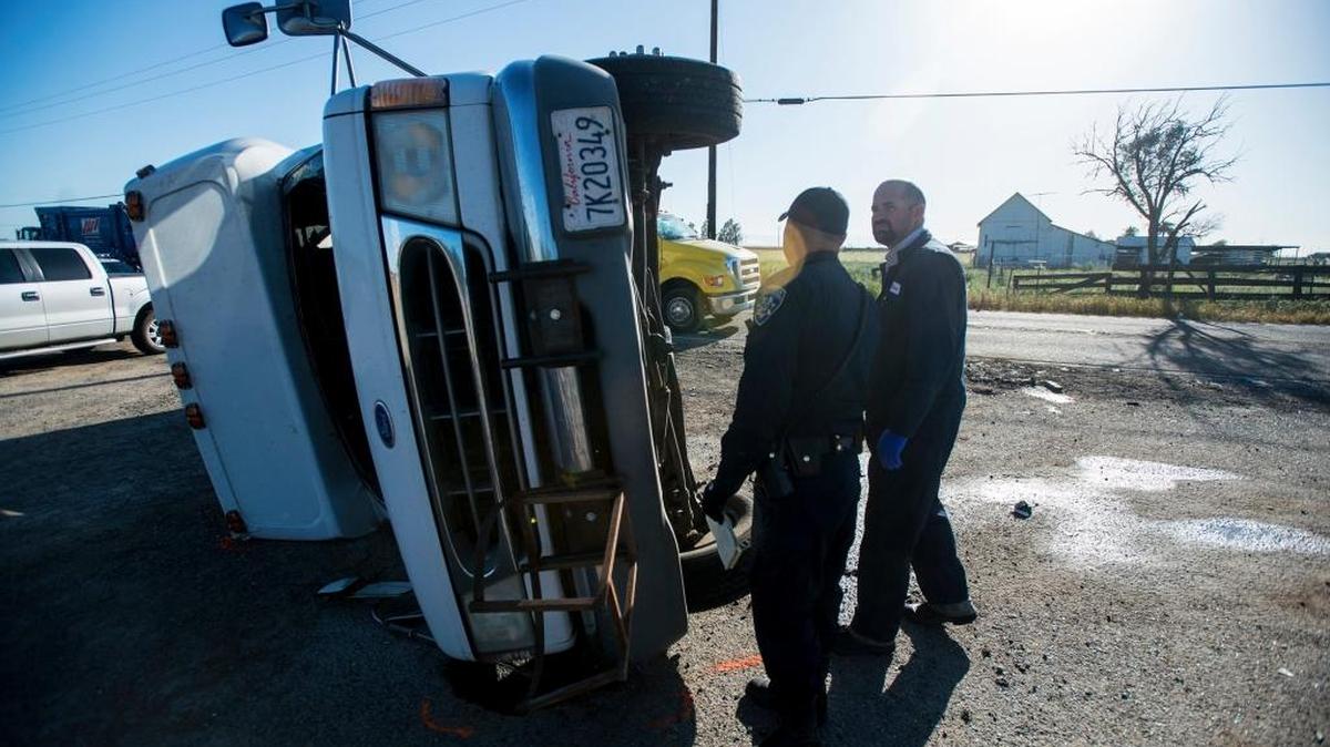 The California Highway Patrol, Merced County Sheriff’s Department and the California Department of Forestry and Fire Protection, Merced County, respond to the scene of a fatal crash involving a bus and a minivan in the 5900 block of North Highway 59 in Merced, Calif., on Friday, April 14, 2017. According to CHP Sgt. Charlie Wilson, the crash occurred when the minivan traveling in the northbound lane, crossed into the southbound lane in an attempt to pass the bus carrying about 20 farmworkers. The bus slowed to make a left turn toward Castle Farms Inc. and the minivan collided with the left rear of the bus causing the bus to overturn. One passenger on the bus was pronounced dead at the scene. The driver of the minivan was trapped in the vehicle and had to be removed by firefighters before he was flown to a Modesto Hospital. A female passenger in the van suffered minor injuries and at least seven other people reported minor injuries, according to the CHP.