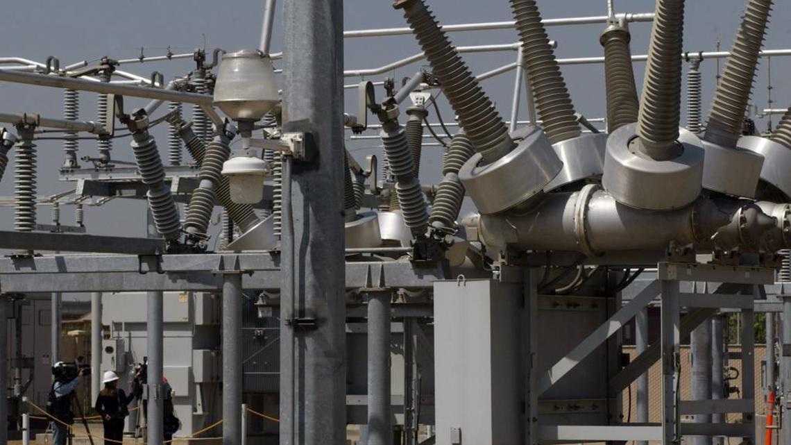 PG&E representatives talk to reporters at an upgraded electricity substation in Fresno in this 2008 file photo. A new high-voltage line across Fresno County, between substations near Coalinga and Madera, has been put on hold by the California Independent System Operator because of the rapid growth of solar power in the area.