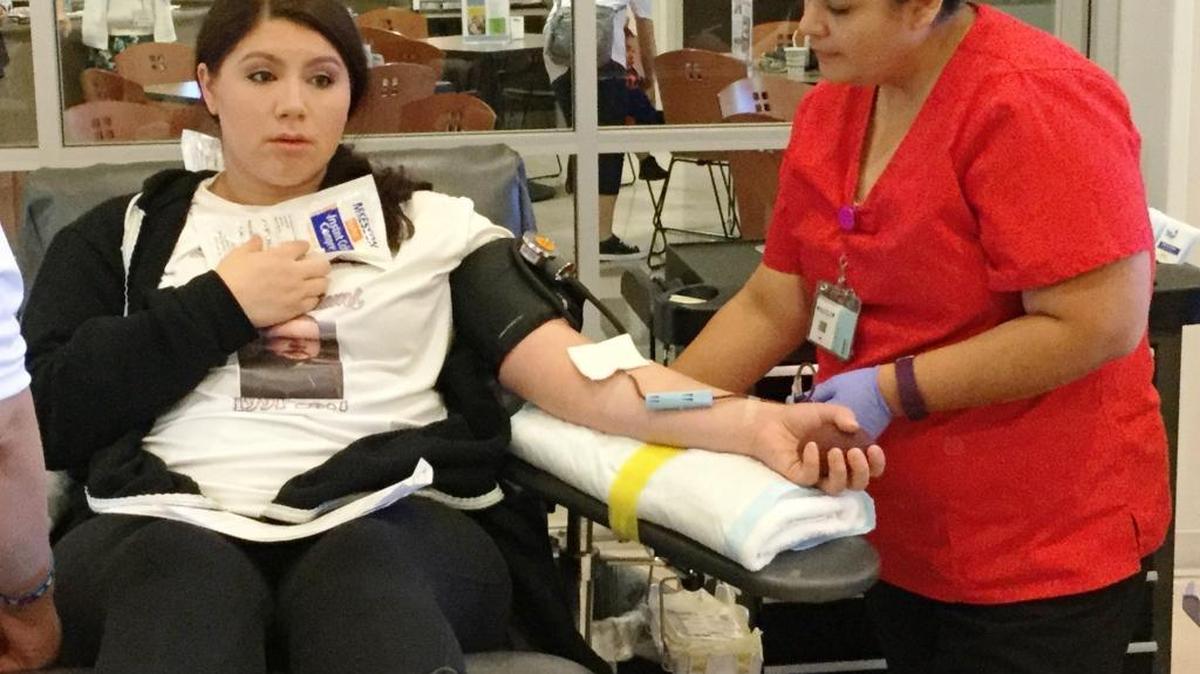Crystal Shirkey reclines as Central California Blood Center phlebotomist Nicole Moreno draws a pint of blood on Thursday, April 20, 2017 in Fresno. Shirkey organized a blood drive in memory of her brother, Carl Allen Williams III, who was shot and killed April 13 while on duty at a Motel 6 in central Fresno.