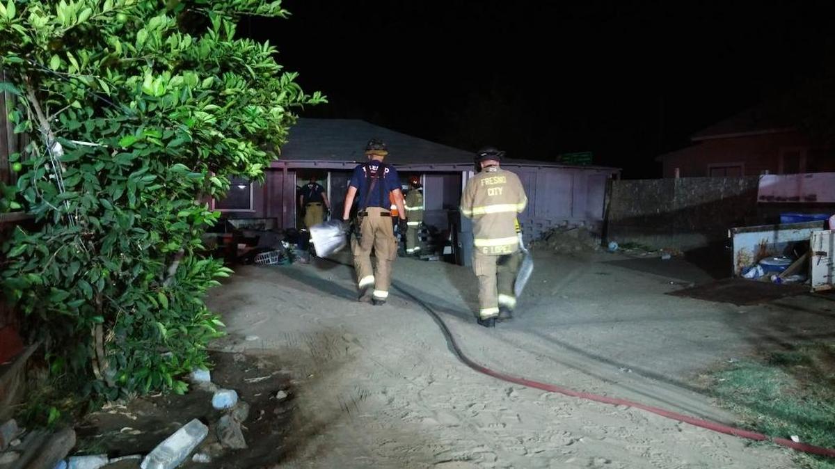 Firefighters survey the scene of a house fire that broke out in the 3800 block of East Clay Avenue late Sunday, Sept. 4, 2016, in central Fresno. Damage to the home was estimated at $5,000.