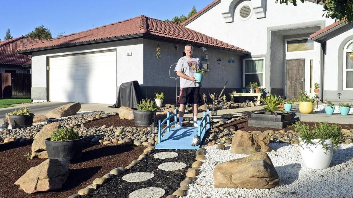 
FACES OF THE DROUGHT: When the drought-related water restrictions were enacted in Clovis, Terry Mackey and his wife, Marcie, knew they’d have an even harder time keeping their front lawn green. So they built their own low-maintenance, low water-use xeriscape. “We don’t have green thumbs. Everything we try to grow dies, so we put in a landscape with only full sun and drought-resistant plants and so far it’s doing pretty good.” The Mackeys are among those featured in The Bee’s ongoing series, “Faces of the Drought.” See more at www.fresnobee.com/water
