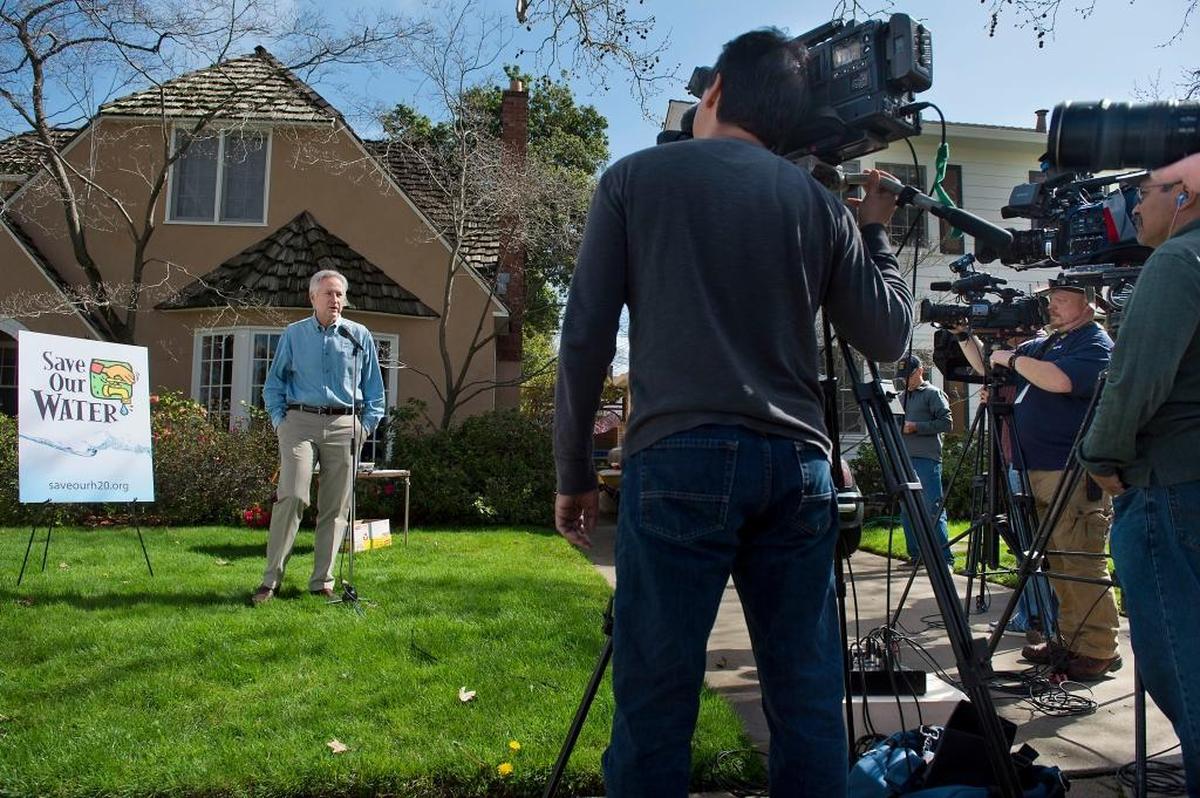 Mark Cowin, then the director of California’s Department of Water Resources, speaks about water conservation – including turning off sprinklers – during a 2014 news conference about the drought at a home in Sacramento.
