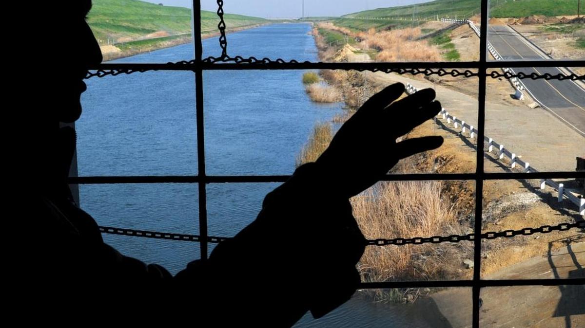 Ron Silva of the US Bureau of Reclamation talks about the six pumps that raise water from the southern Sacramento-San Joaquin Delta, in the background, into the Delta-Mendota Canal at the Tracy Pumping Plant on Tuesday, February 12, 2013 near Tracy, Calif.