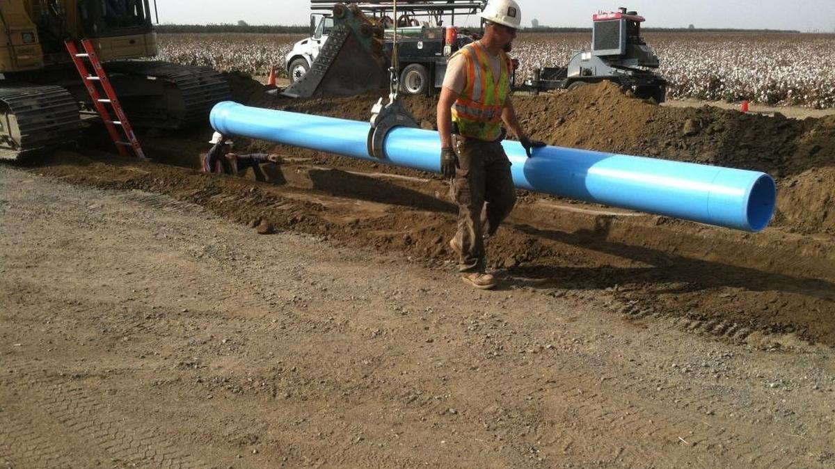 In October 2013, workers lay water pipe near Matheny Tract.