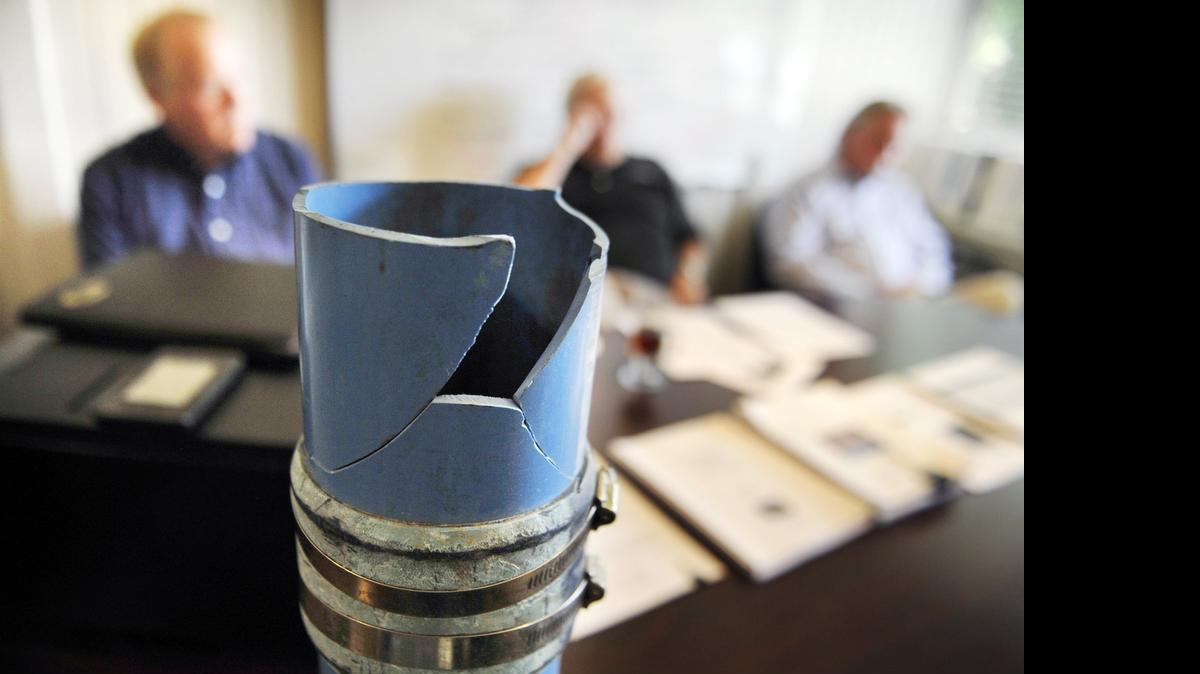 
A four-inch irrigation pipe installed in the 1970s and used for the community’s water supply is shown cracked as Yosemite Lakes Owners’ Association officers, background, discuss their 20-year plan to replace pipes like this one and repair roads at Yosemite Lakes Park near Coarsegold, California, Thursday, July 2, 2015. The infrastructure for its water supply is in need of replacement and the roads need repair. The Yosemite Lakes Owners’ Association is doing the work through its own utility company.
