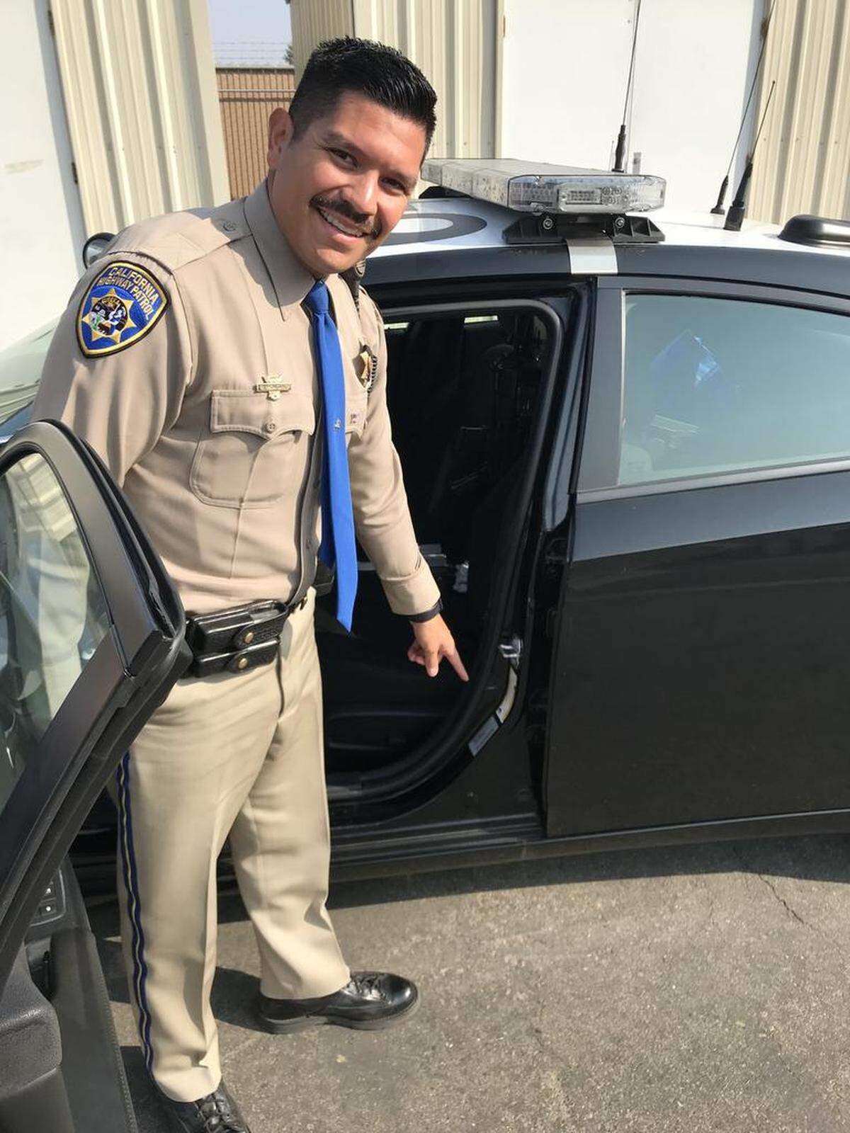CHP officer Robert Montano shows where in the door jam of a vehicle the tire-pressure information can be found.