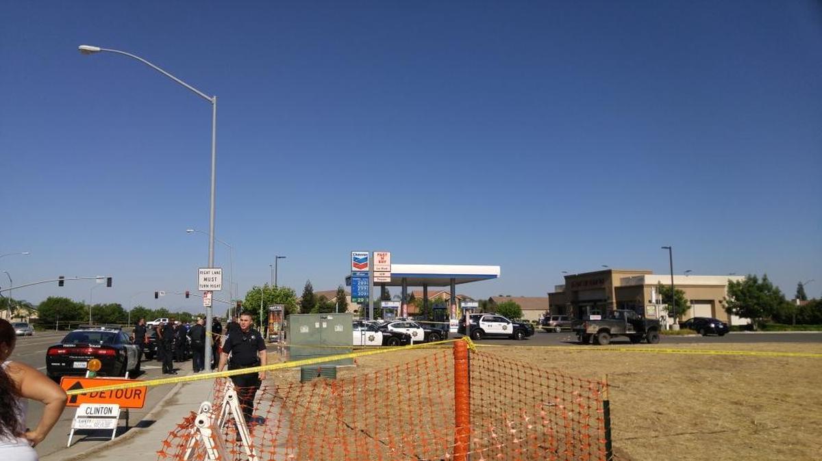 Fresno police converge at the scene of an officer-involved shooting at the Chevron gasoline station at Shields and Armstrong avenues in east-central Fresno.